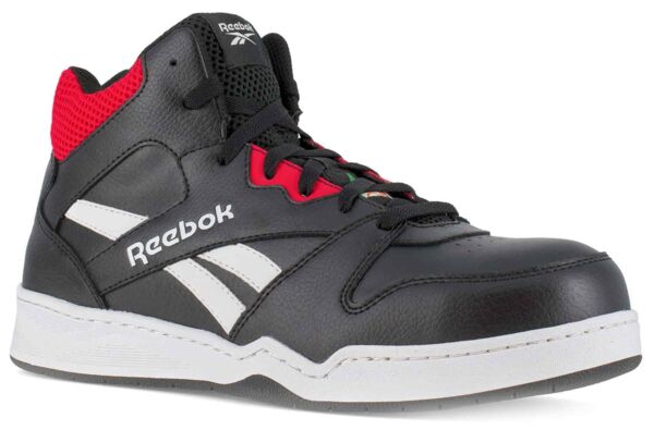 The shoe is a black basketball shoe with red accents. It features high lacing, a rubber sole, and a prominent logo on the side. The surface is made of leather.