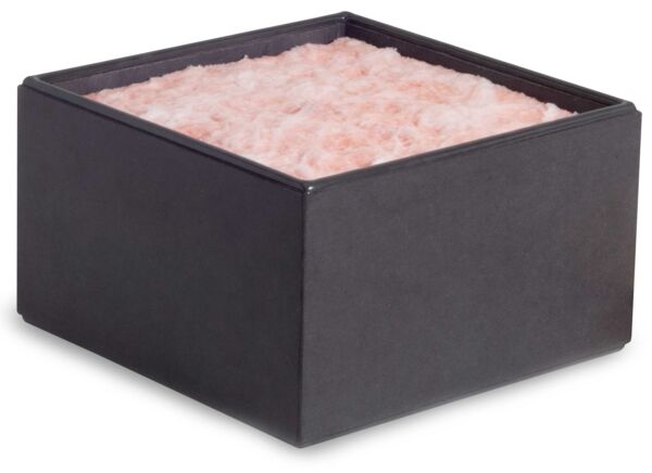 The image displays a square container with a smooth, black exterior. It is filled at the top with a pink, fluffy substance.