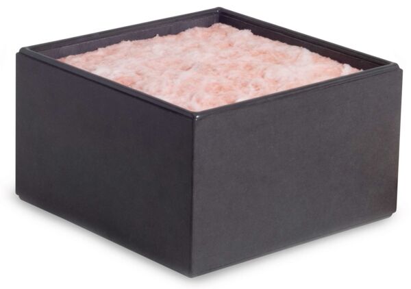 The image shows a black, square container with a soft, pink-colored content that looks like cotton. The surface is fluffy and uneven.