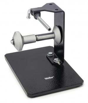 The image shows a sturdy, black holder with an adjustable metal clamp mounted on a base. It bears the brand 