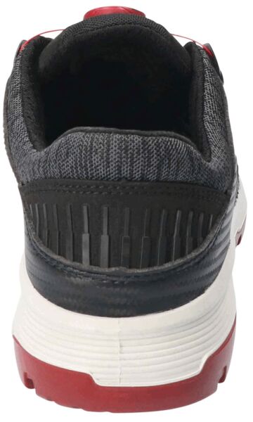 The image shows the back of a sports shoe. It is predominantly black with gray upper material and features a striking red sole. The structure is modern and functional.