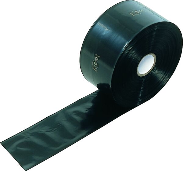 The image shows a large roll of black, glossy tape. A section of the tape is unrolled and extends across a flat surface. The roll has a central core hole.