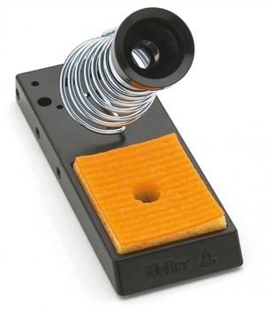 The image shows a soldering iron stand. It consists of a rectangular black base with an orange sponge. At the top, there is a spiral holder for the soldering iron.