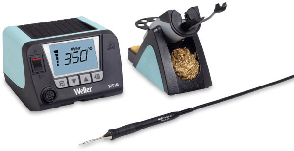 The image shows a soldering station with a digital display indicating 350 °C. Next to it is a holder for the soldering iron, which contains a brass cleaning wool.