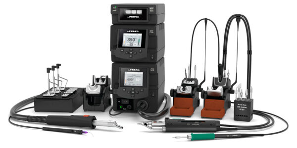 The image displays a set of soldering tools: three digital control units, several soldering tips, a desoldering pump, and additional handheld devices. Everything is arranged on a table.