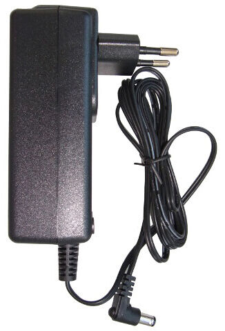 The image shows a black power adapter with two socket pins on one side and a cable leading to a round plug. The cable is coiled and moves sideways.