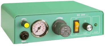 The image shows a green device with a pressure gauge, a black rotary knob, and a yellow button. It has switches for 