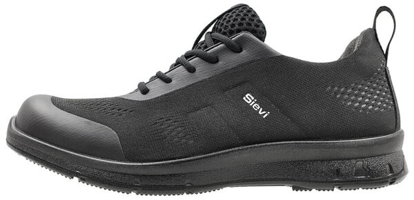 The image shows a black athletic shoe with a flat sole. It features full lacing, a breathable upper, and a reinforced toe cap. The brand 