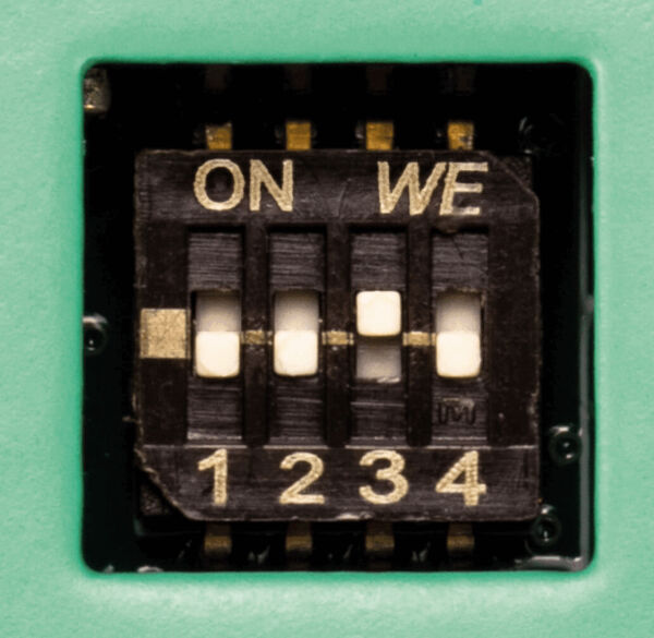 The image shows a switch labeled "ON" and "WE" on a black background. Below are the numbers 1 to 4 in light font. The switch has three movable elements.