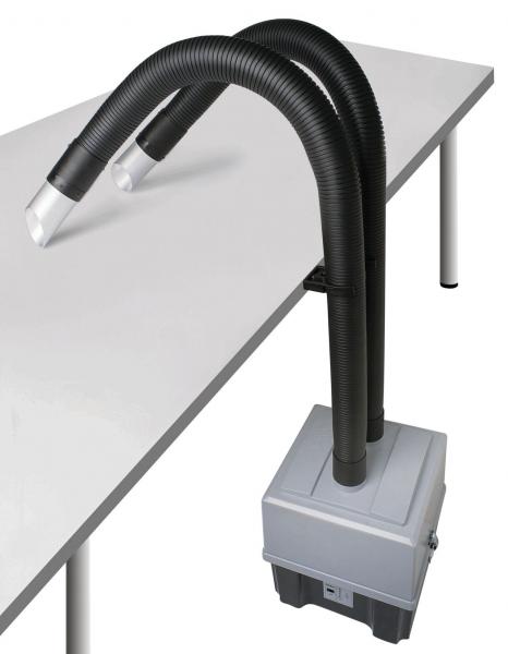 The image shows a device with two flexible hose arms extending from a square casing on a table. The hoses are black and round at the ends.