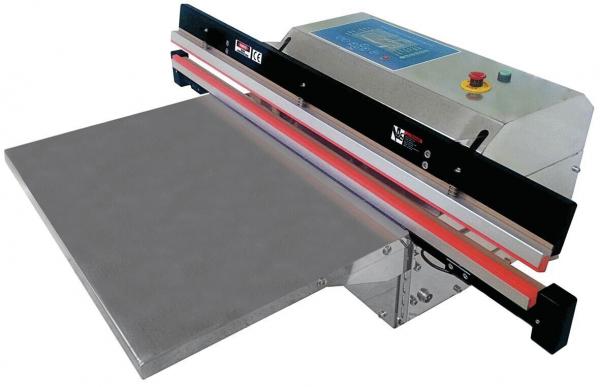 The image shows a sealing machine. It has a large, flat working surface and an upper flap with controls. The machine appears sturdy and is designed for sealing materials.