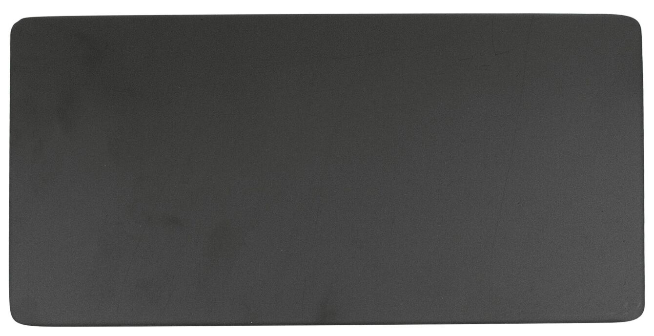 The image displays a smooth rectangular surface in matte black. The edges are rounded and the surface appears uniform and patternless. It is flat and stable.