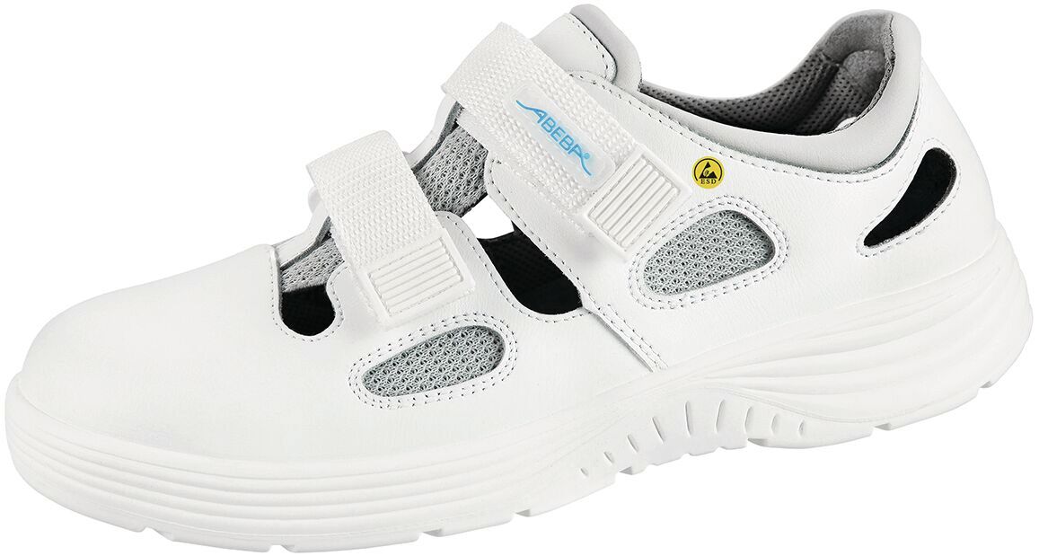 The shoe is white with gray and black details. It has a curved, non-slip sole, two Velcro straps, and breathable inserts. Ideal for comfort and support.