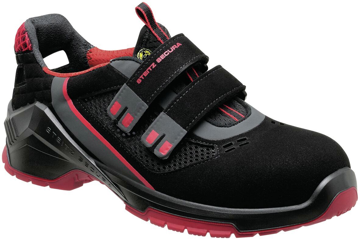 This is a sporty shoe in black with red accents. The shoe has a sturdy look, is partially made of mesh material, and has two elastic Velcro straps.