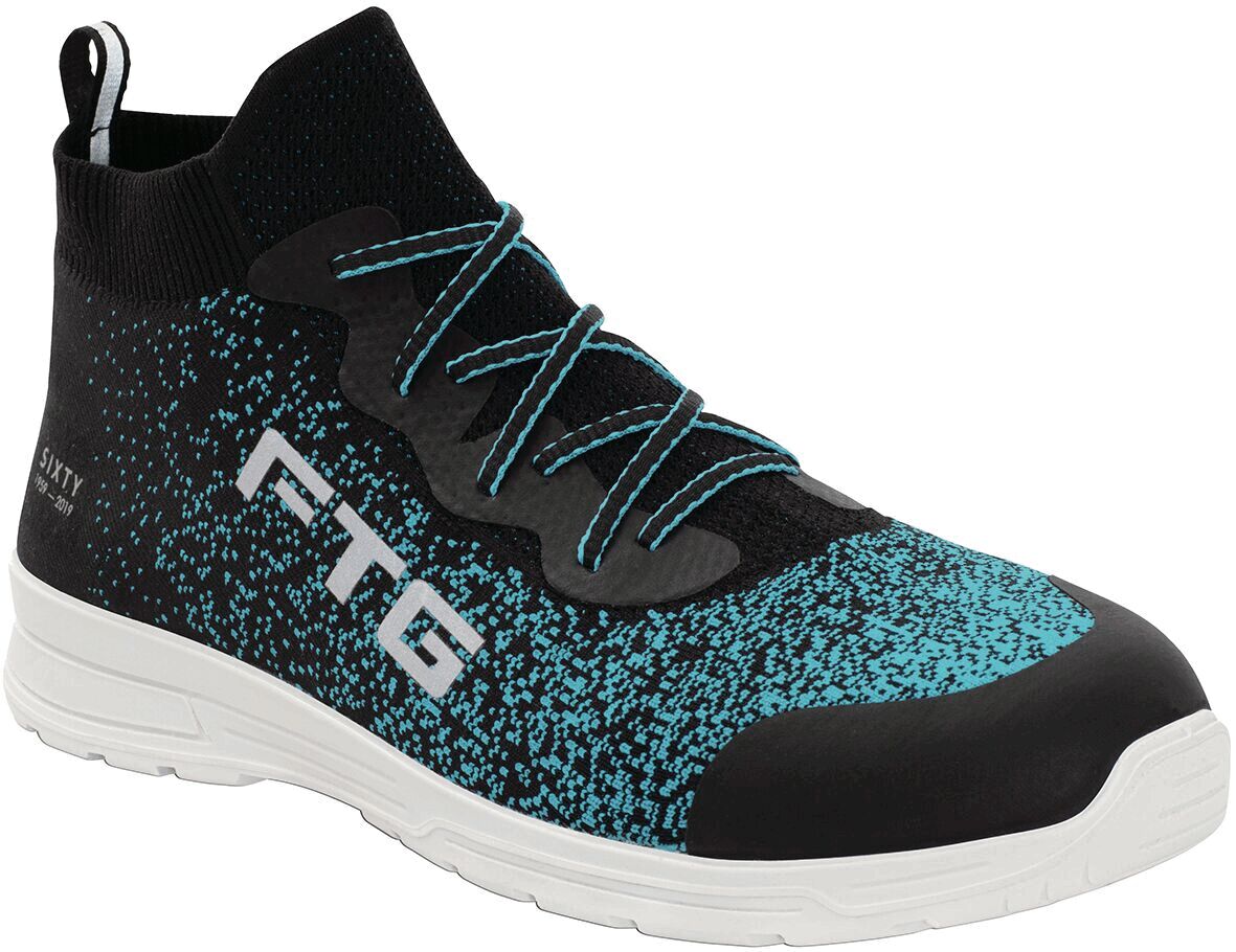 The shoe has a tall, black upper with turquoise patterning. It is sportily cut, with an elastic shaft and a white sole. The side reads "FTG".