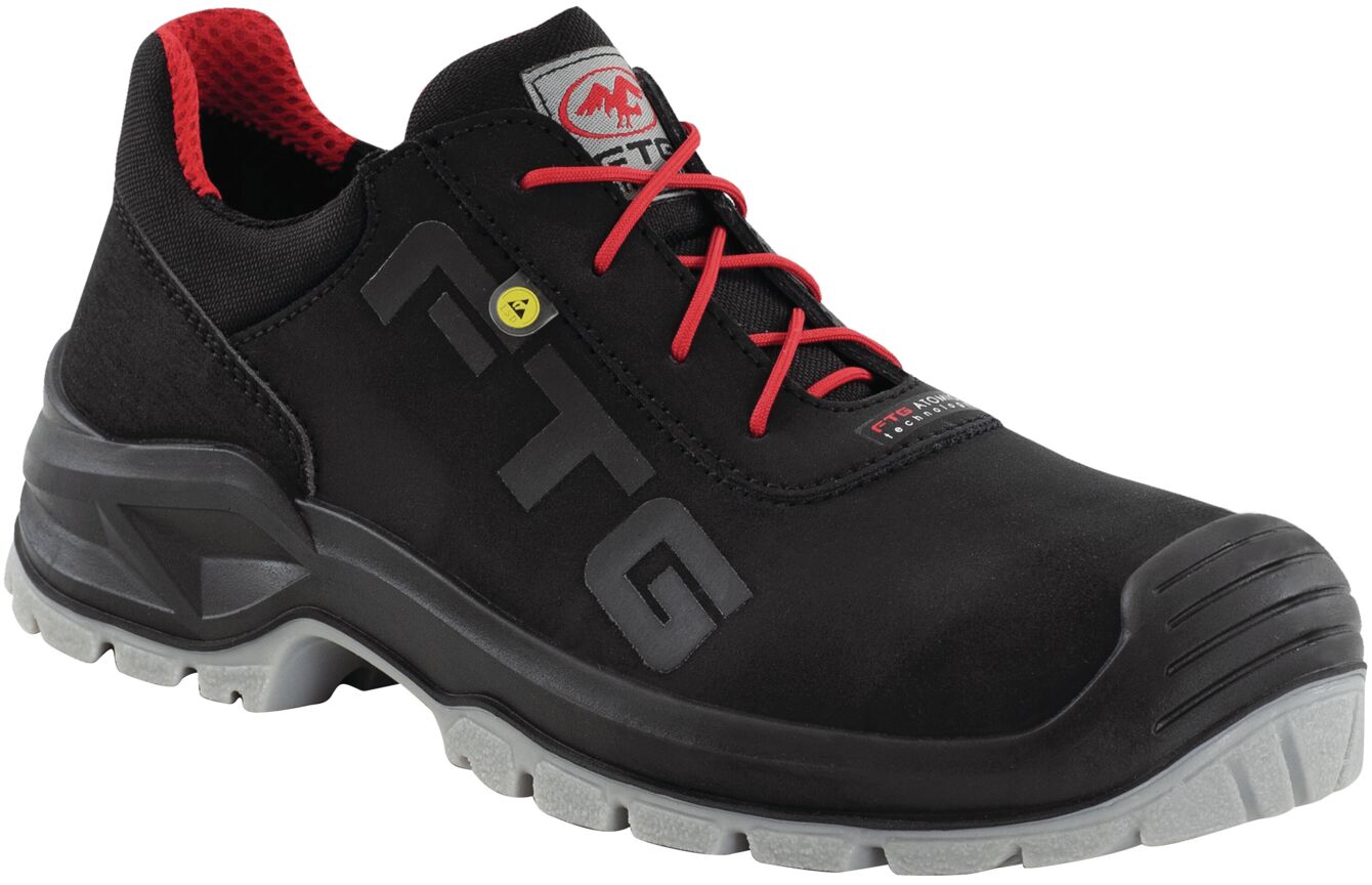 The shoe is sporty and black with red laces. It has a sturdy, gray sole and a modern design, ideal for safer, comfortable use in the workplace.