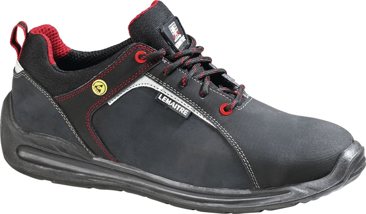 The shoe is a black sneaker-like work shoe with red accents. It has a padded sole, laces, and a logo on the side. The fabric is sturdy and durable.