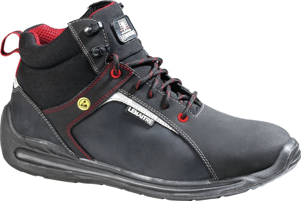 The shoe is a black, mid-height work boot with red accents. It features a sturdy sole, laces, and side reinforcements for extra support and protection.