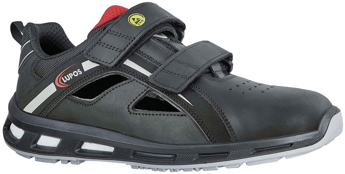 The shoe is black with gray and red accents. It has two wide Velcro straps and a breezy design with side holes. The sole is sturdy and lightly textured.