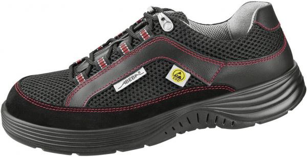 The shoe is a sporty, lightweight half-shoe made from black, breathable material. It features red accents, a flexible sole, and tight lacing. Ideal for casual or work use.