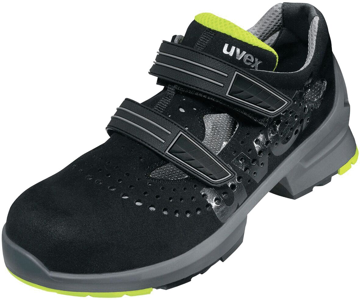 The shoe is black with light green accents. It has two practical Velcro straps and a reinforced sole. The upper material features ventilation holes for comfort.