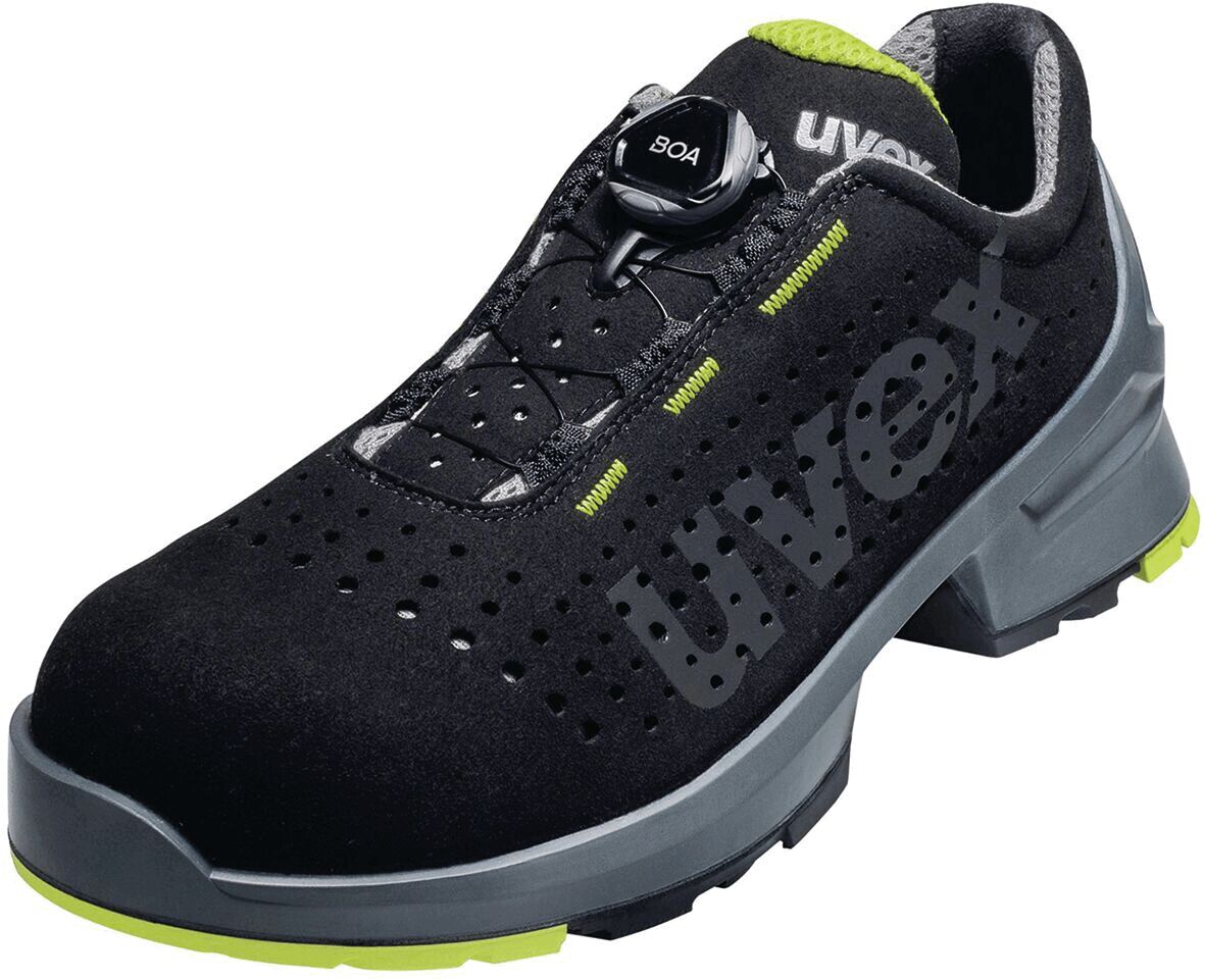 The shoe is black with gray and neon-green accents. It has a non-slip sole, lacing system with a twist lock, and a perforated surface for ventilation.