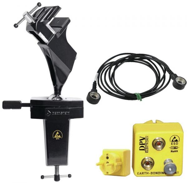 The image shows a black, metallic tool with a holder, a cable with round connectors, and a yellow, square box with two connectors.