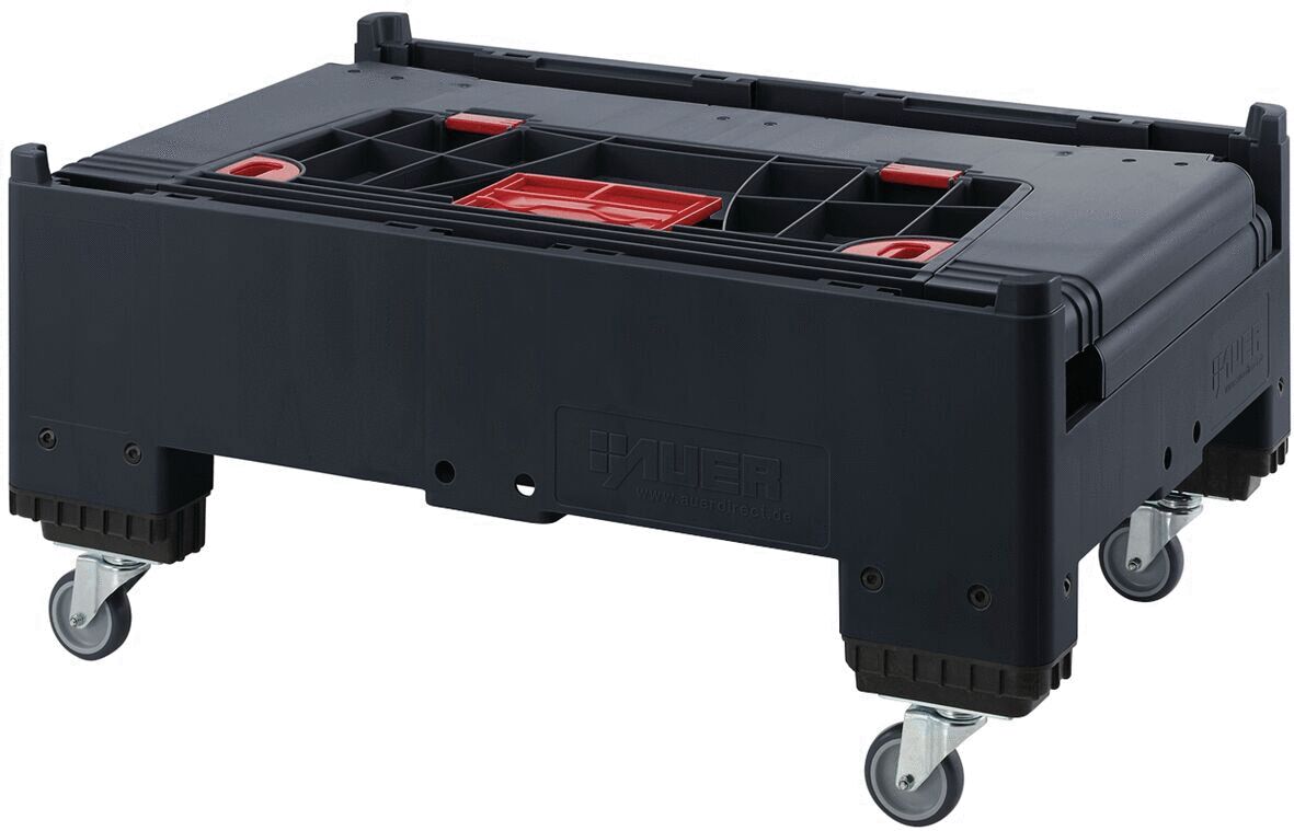 The image shows a rectangular, black transport box on wheels. It has a flat surface with several small compartments and a red insert in the middle. The corners are rounded.