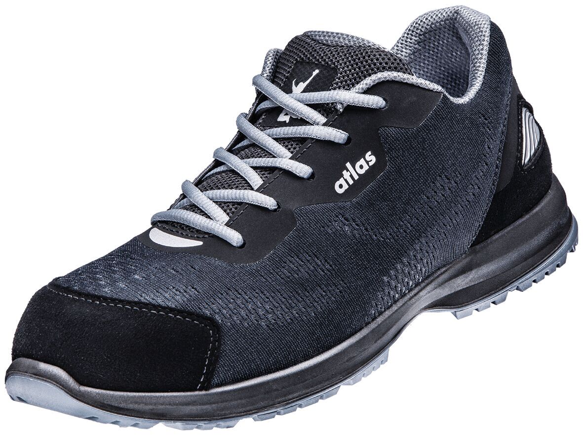 The shoe is sporty and lightweight, predominantly black with gray accents. It has a flat sole, narrow laces, and a breathable upper. Ideal for active use.