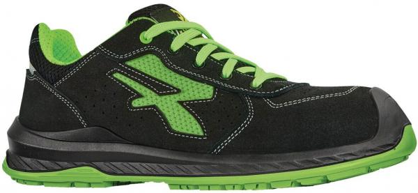 The shoe is black sneakers with green accents and laces. It has a grippy, black rubber sole and a sporty, comfortable shape. The surface is partially perforated.