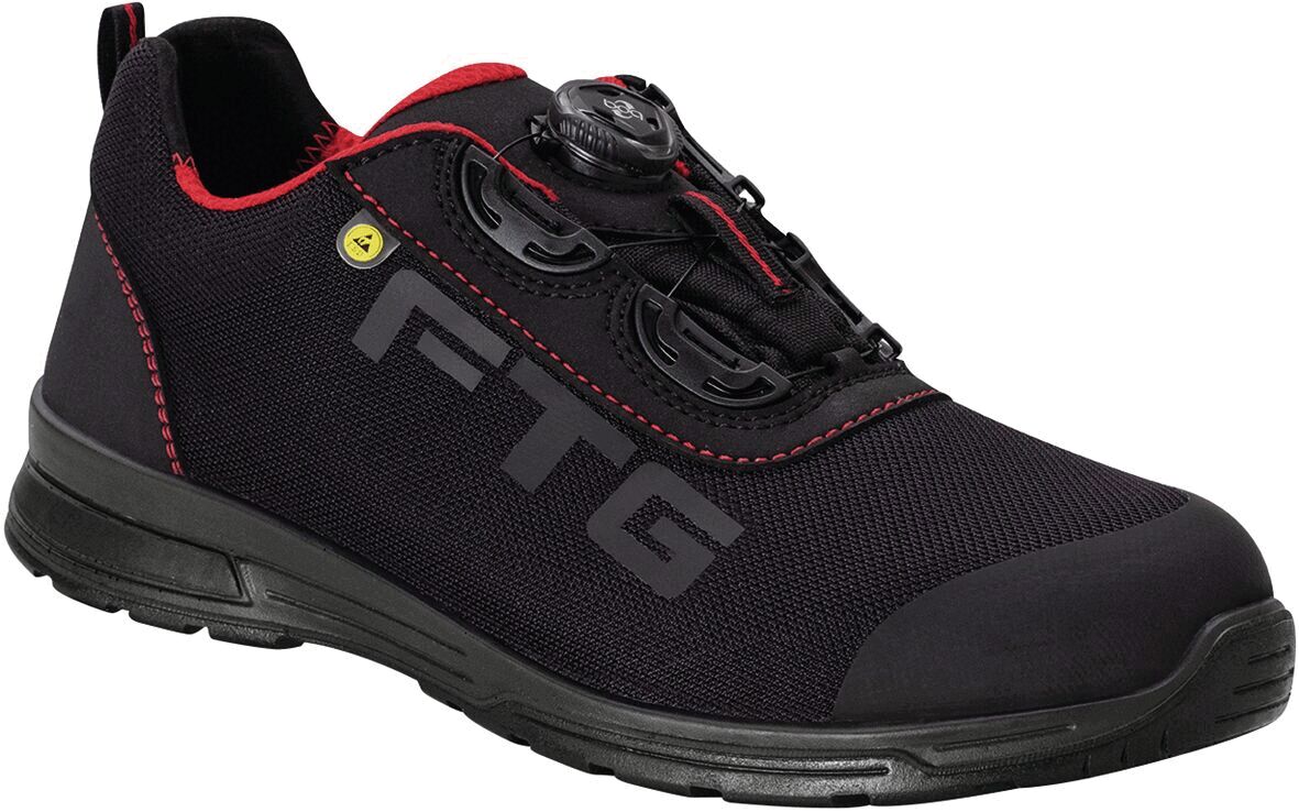 The shoe is sporty and black with red details. It has a modern look, a flat sole, and at the lacing there are compact, round closures for easy adjustment.