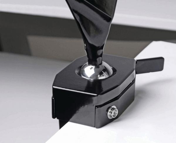 The image shows a black clamp with a ball at the top end. The clamp has a lever on the side and is used to hold objects securely. The surface appears smooth and shiny.