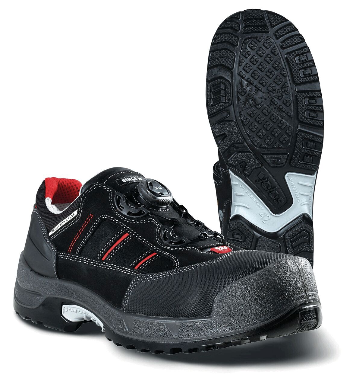 The image shows a black safety shoe with red lining. It features a reinforced toe cap and a modern lacing system. The sole is slip-resistant with a deep tread.