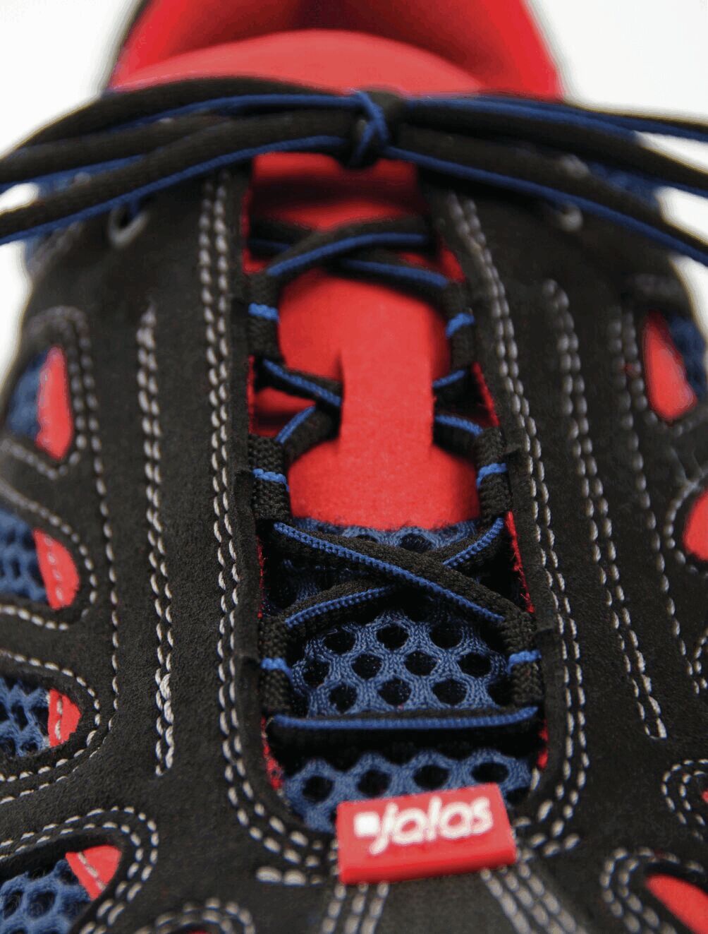 The image shows a sports shoe in black and red with blue shoelaces. The surface features a mesh design, and the brand logo "jalas" is clearly visible.