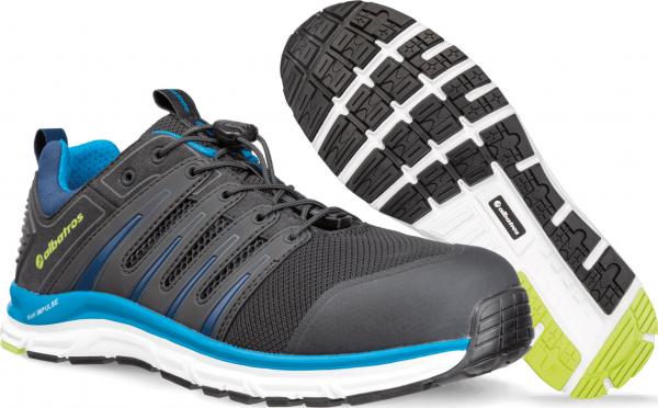 The image shows a sporty shoe in black with blue and green accents. The sole is textured and has various structures for good grip.