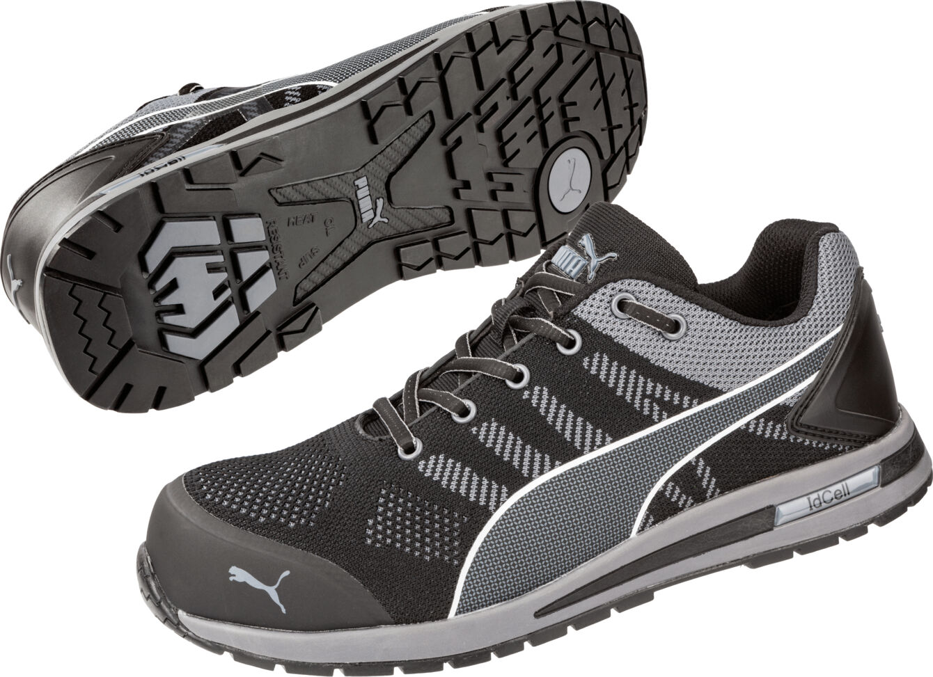 The image shows a pair of athletic shoes in black and gray. They have a non-slip sole with a coarse tread and are designed on the upper with mesh and leather parts.