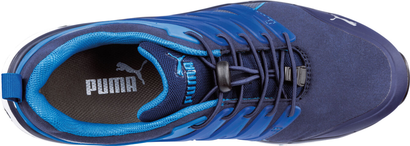 The image displays a blue sports shoe from Puma. The upper part is dark blue, with light blue accents and laces. The lining is also in a light blue shade.