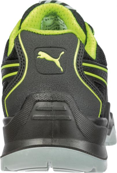 The image shows the back of a black sports shoe with bright green accents. A Puma logo is visible on the heel area. The sole is gray and somewhat cushioned.