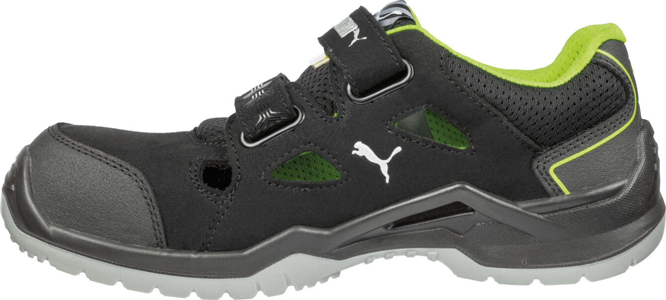 The shoe is black with green accents. It has a closed yet ventilated construction, a sturdy rubber rim, and a non-slip sole. It is sporty and comfortable.