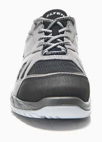 The shoe is sportily designed, predominantly gray with black details. It has a lace-up front and a flexible, light sole. The combination of materials appears breathable and modern.