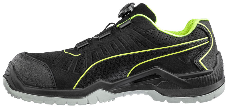 The shoe is sporty and black, with bright green accents. It features a special laceless fastening and a sturdy sole for good grip and comfort.