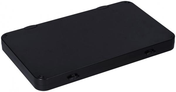 The image shows a flat, rectangular box in matte black. The edges are rounded, and there are two small recesses on the side. It appears simple and modern.