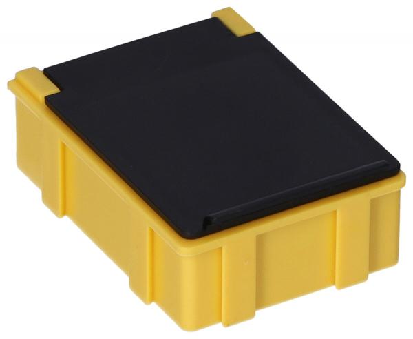 It is a small, square box. The bottom is bright yellow and has a textured surface, while the lid is black and smooth. The edges are rounded.