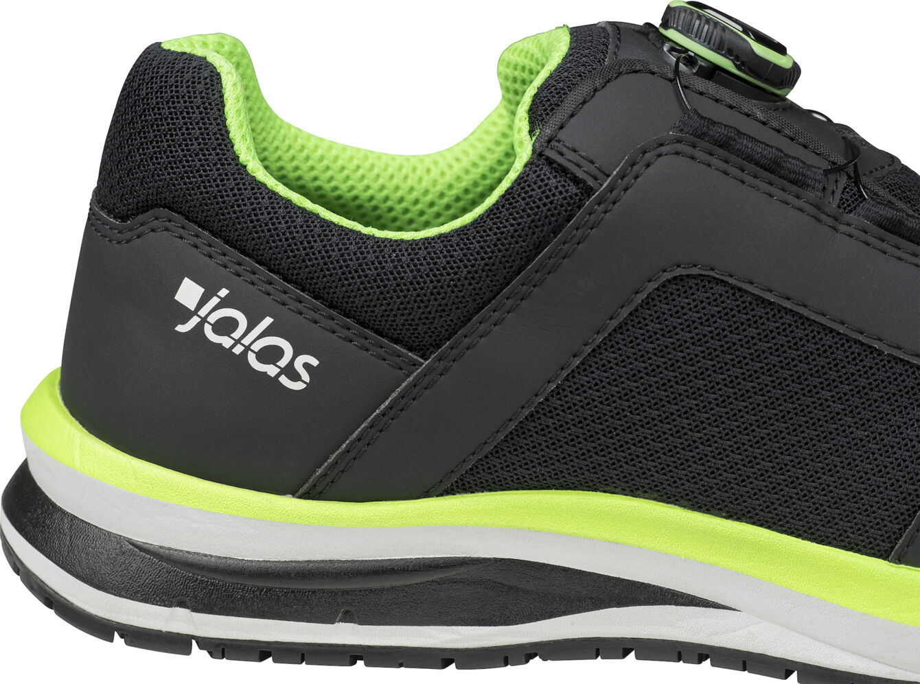 The image shows a black sports shoe with green accents. It has a textured surface and a white sole. The "jalas" logo is visible on the side.