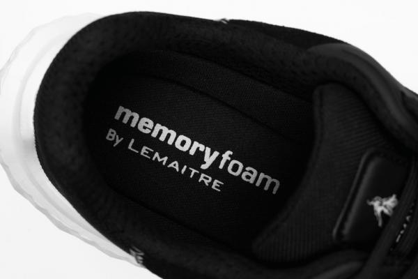 The image displays the insole of a shoe. The upper part is black with white text that reads "memory foam" and "By Lemaître." The shoe appears sporty and modern.