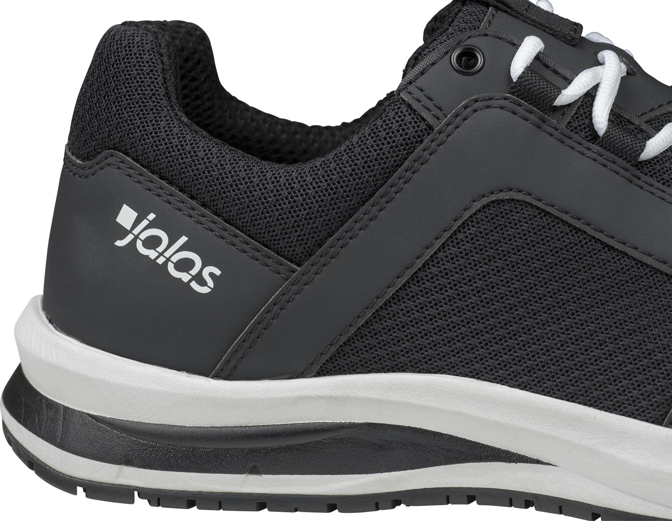 The image shows a black sports shoe with a breathable textile upper. The sole is white with a black underside, and the shoe has a modern, sporty shape.