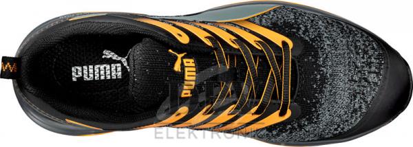 The image shows a sports shoe from above. It has a patterned upper in black and gray, with orange accents and laces. A Puma logo is visible on the tongue.