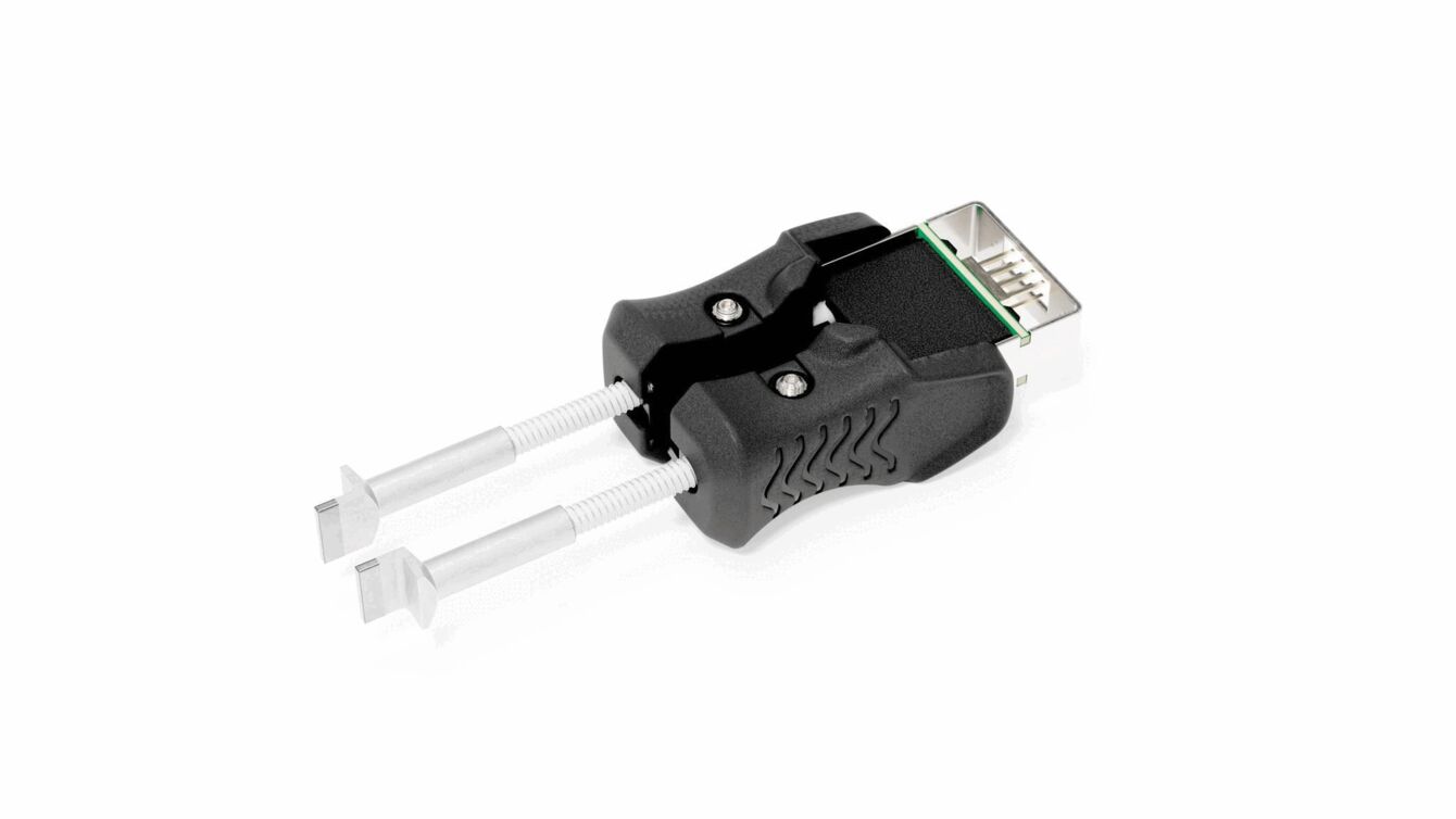 The image shows an adapter with two gripping handles and a USB port. The handles are made of black plastic, while the two ends are metallic and function like clamps.