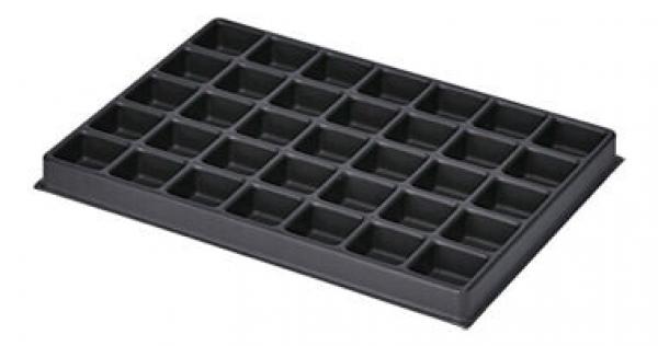 The image shows a black plastic mold with 36 small square compartments. The compartments are evenly arranged and are likely used for storing or shaping materials.