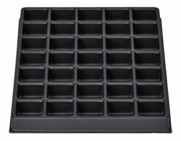 The image shows a rectangular, black baking pan with 36 evenly distributed, small indentations suitable for muffins or cupcakes. The surface is smooth.